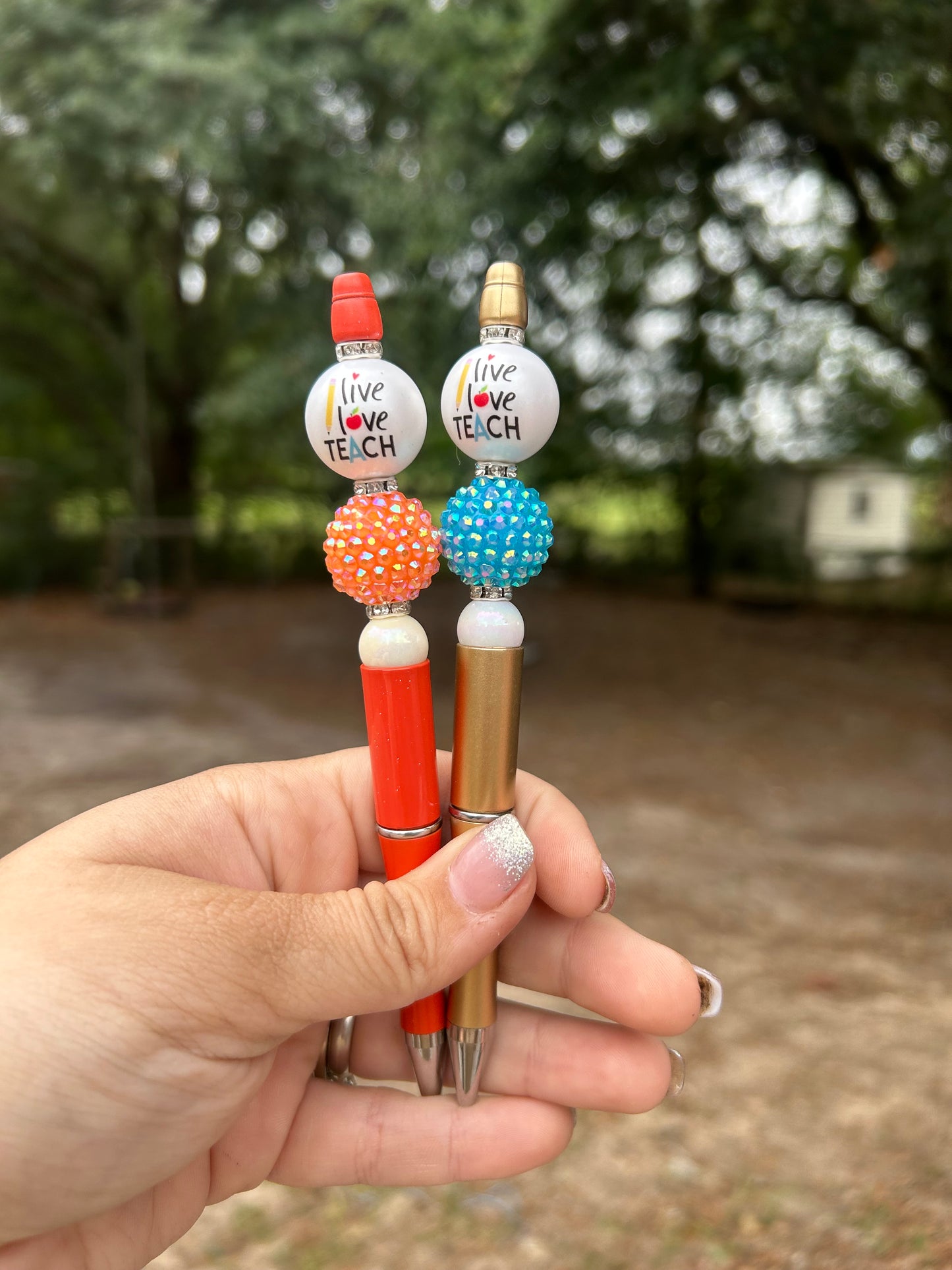 "Live love teach" decorative pens.